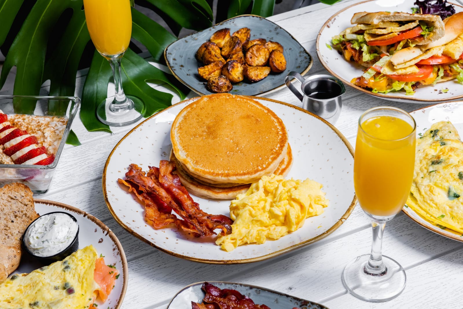 A breakfast spread of pancakes, eggs and bacon at Crema Gourmet in Coral Gables