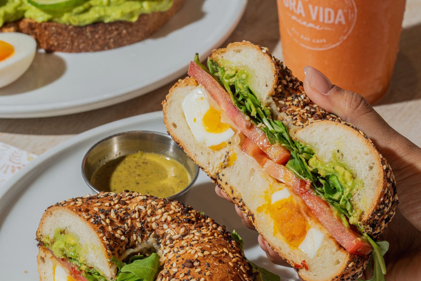 Bagel sandwich with egg and avocado toast at Pura Vida on Miracle Mile