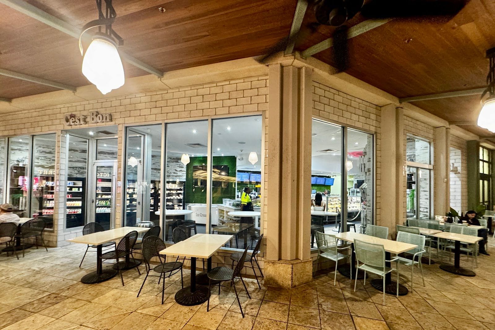 Covered walkway seating outside C'est Bon at Shops at Merrick Park, Coral Gables