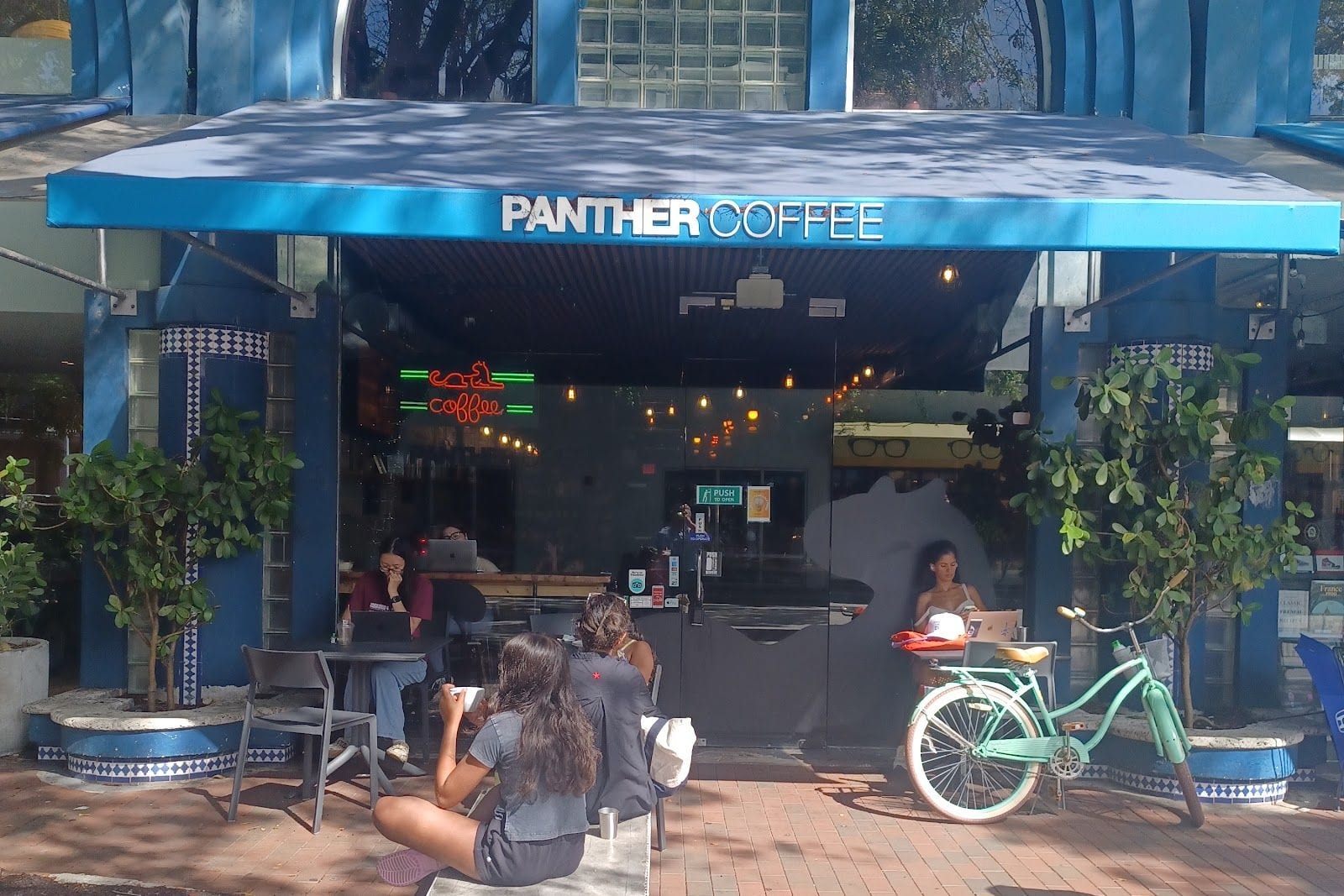 The Panther Coffee storefront and plaza seating on Main Hwy in Coconut Grove