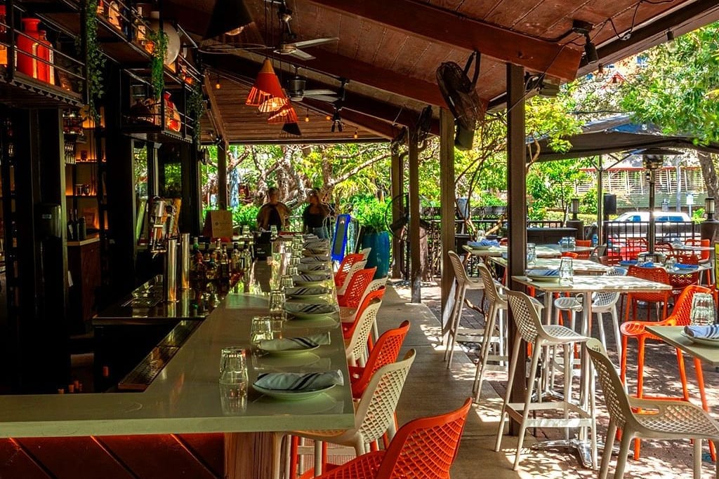 The covered outdoor dining area of Glass and Vine inside Peacock Park, Coconut Grove