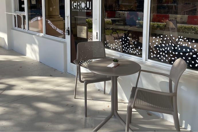 Sidewalk terrace table and chairs outside GROU Coffee and Cowork on Salzedo St, Coral Gables