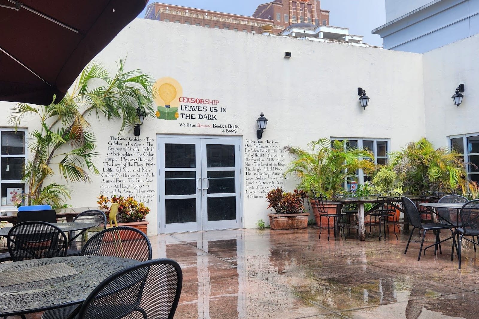 Courtyard tables and umbrellas at The Cafe at Books and Books in Coral Gables