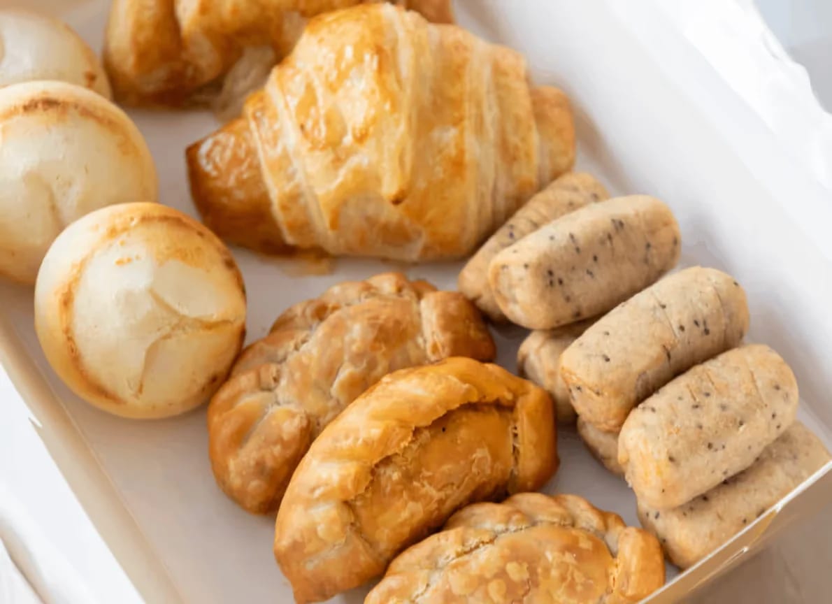 Catering box of GROU pan de bono, croissants, empanadas and tequeños